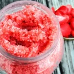 Homemade strawberry sugar scrub in a bowl with fresh strawberries