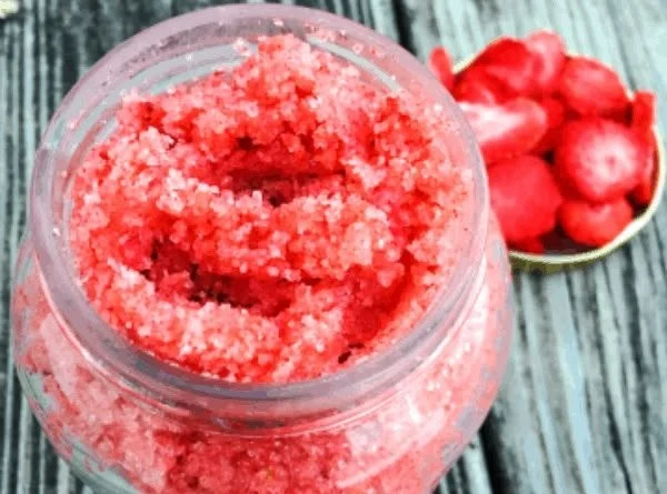 Homemade strawberry sugar scrub in a bowl with fresh strawberries
