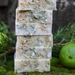 Homemade lime cedarwood soap bars in a rustic setting.